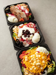 Variety of salads in takeaway containers