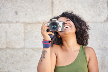 Young female tourist laughing holding camera with copy space for text. Concept of tourism