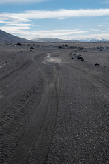 Typische Piste im Hochland von Island. Eine Spur durch schwarzen Lava