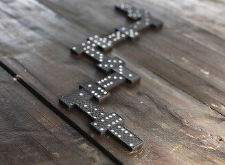 Domino pieces on wood table in order of game. Concept of way.