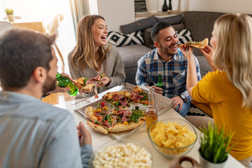 Friends eating pizza at home party