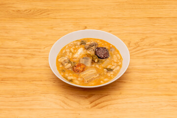 delicious first course Spanish winter dish of cocido montañes with white beans, bacon, chorizo, black pudding of rice and chard