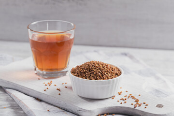 Bowl of fenugreek seeds and Egyptian fenugreek yellow tea or Methi Dana drink
