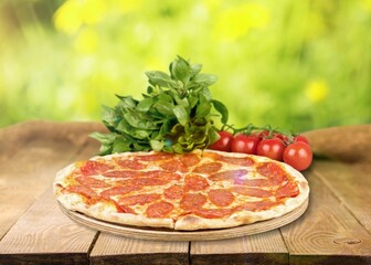 Fresh tasty pizza dish on the desk