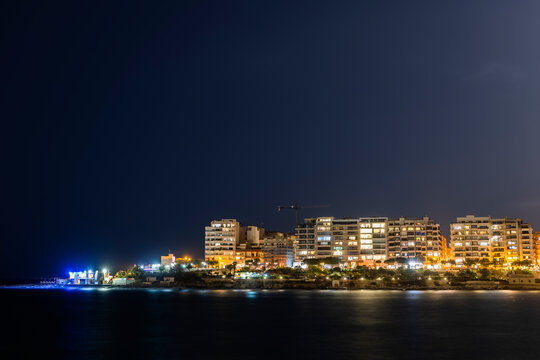 Malta, Sliema, Town skyline at night from St. Julian Bay