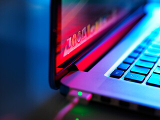 Laptop computer open and on at night