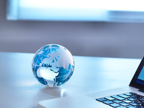 Global Markets, A Glass Globe With A Laptop