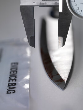 A knife being measured during forensic testing in the laboratory