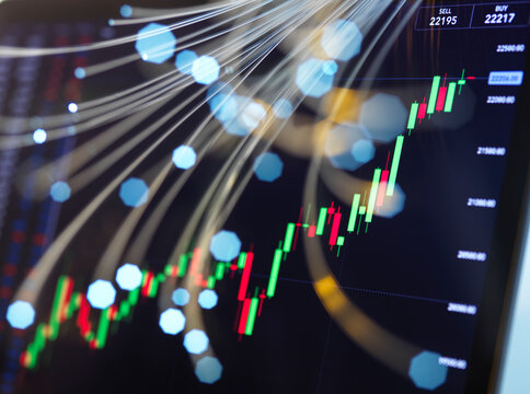 Close-up of computer monitor displaying stock market graphs
