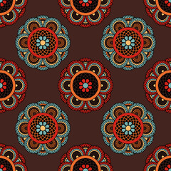 Abstract seamless backdrop. Round colorful texture in red, blue and brown colors. Mandala background. Oriental pattern for design