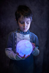 Cute little girl holds the tiny shiny Moon