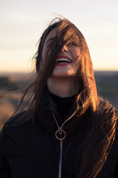 Portrait of laughing teenage girl at sunset
