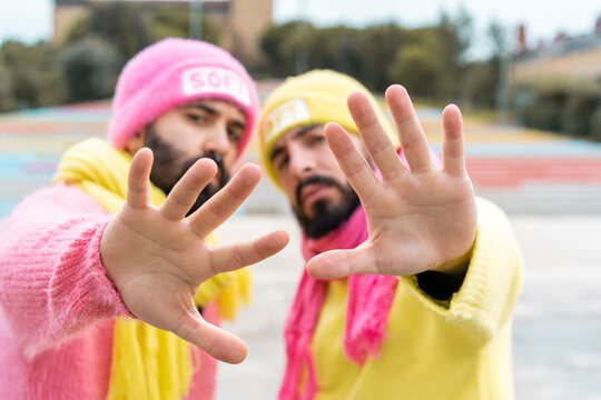 Gay couple raising hands