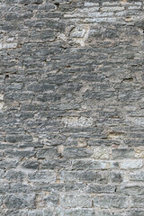 Old brick wall of different size sandstone bricks as a natural background
