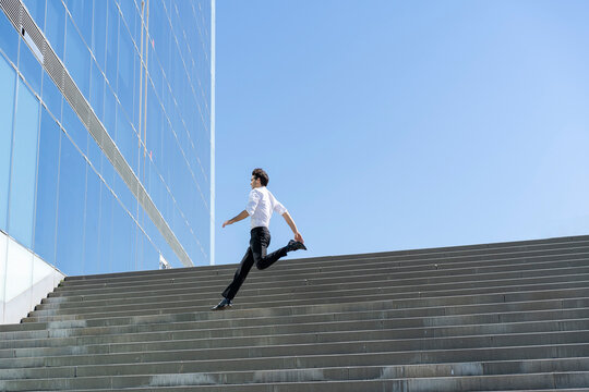 Businessman running on stairs in the city