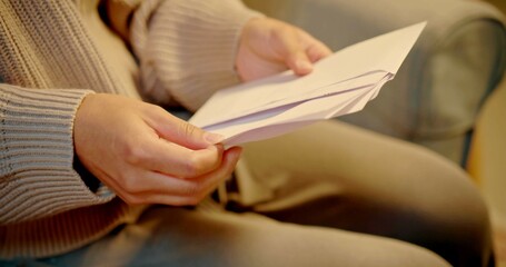 A woman is opening a letter
