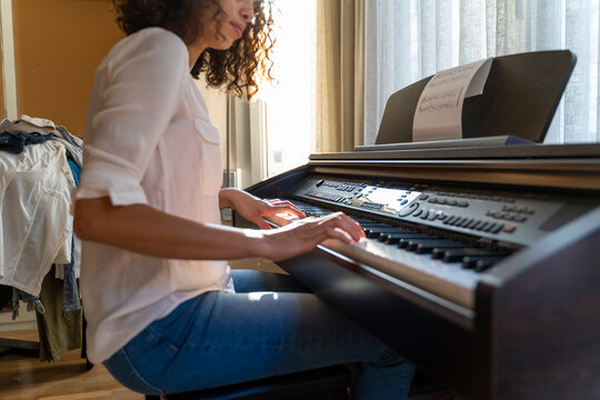 Woman playing piano at home