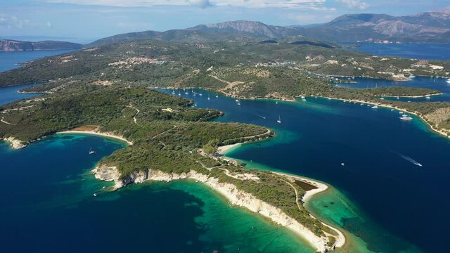 Aerial drone panoramic video of natural fjord bay of Meganisi or Meganissi island a safe anchorage for sail boats featuring crystal clear turquoise beaches, Ionian, Greece
