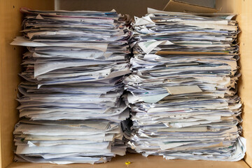 Pile of papers in shelf, close up
