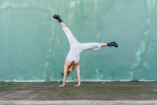Young woman doing handstand