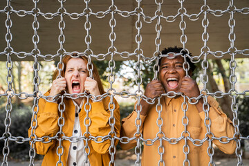 Couple screaming behind chains