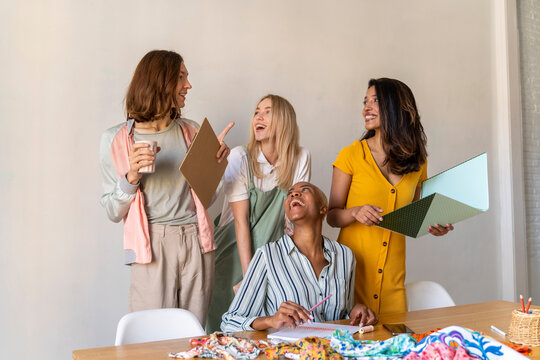 Happy fashion designers having a meeting in office