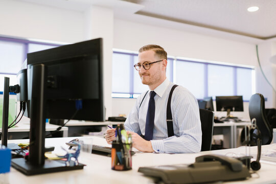 Businessman using computer at desk in office