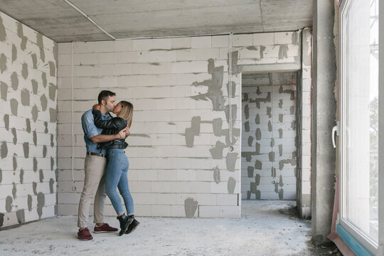 Happy couple of future owners at construction site