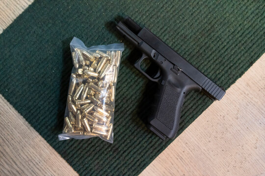 Pistol and cartridges on the table in a shooting range