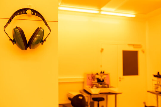 Earmuffs in a laboratory in artificial yellow light