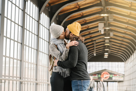 Young couple kissing at a subway station, Berlin, Germany