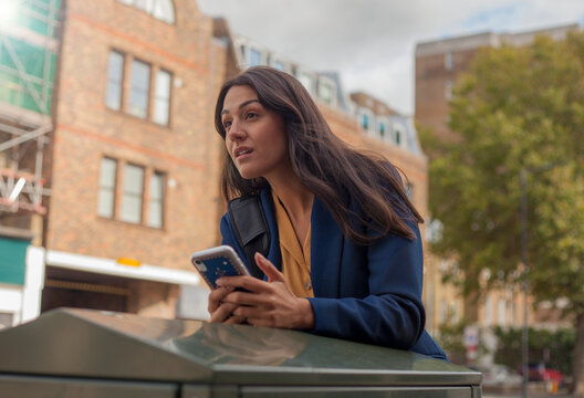 Portrait of woman, using smartphone in the city