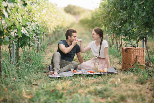 Young couple in love having picnic in the vineyards