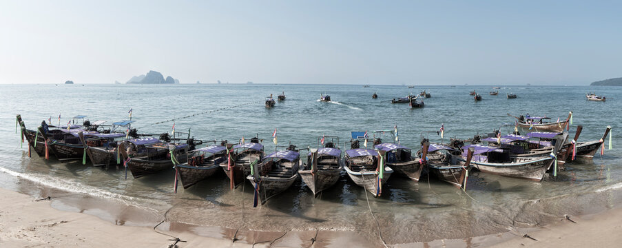 Thailand, Krabi, Railay beach, long-tail boats floating on water at the beach