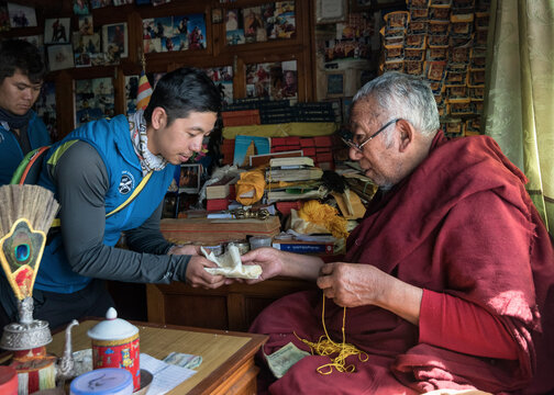 Nepal, Sherpa getting a blessing from moch, before climbing he Mount Everest