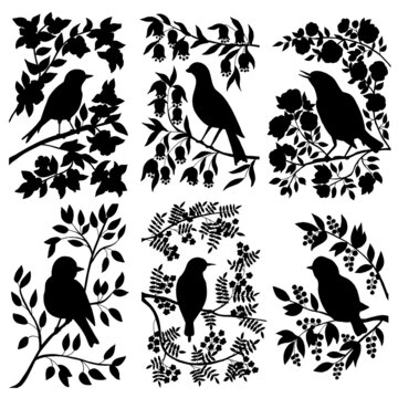 A set of black silhouettes of birds on branches