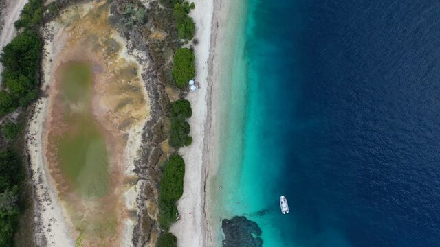 Aerial drone video of exotic turquoise paradise sandy beach forming a blue lagoon in tropical destination island bay