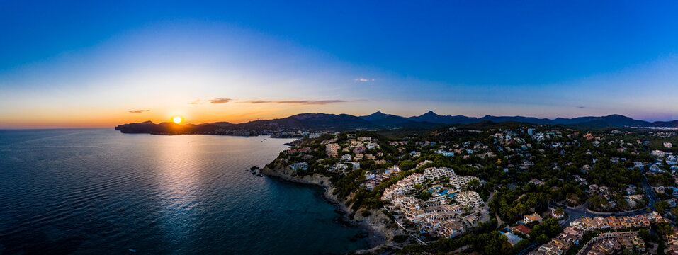 Spain, Mallorca, Santa Ponsa, Aerial panorama of coastal town at sunset