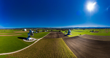 Germany, Bavaria, Aerial view of large parabolic antennas of the earth station Raisting and green fields