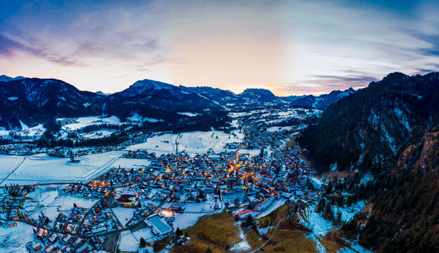 Germany, Bavaria,&Ocirc;&oslash;&Omega;Reit&Ocirc;&oslash;&Omega;im&Ocirc;&oslash;&Omega;Winkl, Helicopter view of&Ocirc;&oslash;&Omega;snow-covered&Ocirc;&oslash;&Omega;mountain village at dawn