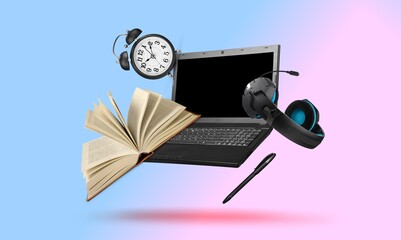 Creative minimal composition made with a laptop, headphones, school supplies and clock flying in the air.