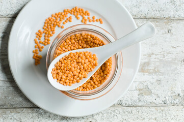 Jar of Orange lentils on plate seen from above