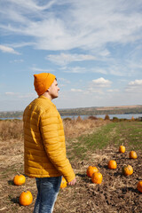 Man in Halloween pumpkin patch field in sunny day