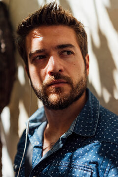 Portrait of bearded man with earphones