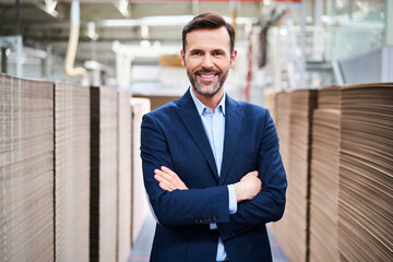 Portrait of smiling businessman in factory warehouse