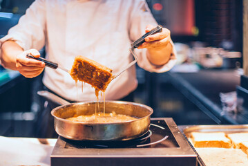 Chef creating a cake in the kitchen of a restaurant