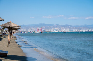 Beach unbrellas and chairs on sunny sandy beach Lady's mile in Akritori, Cyprus