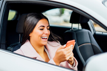 Businesswoman using smartphone in the car