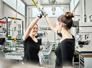 Two women at work, high five