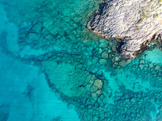 Crystal clear blue water of Mediterranean sea on Fig tree beach in Protaras, Cyprus, top view